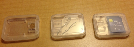 SIM Card, paperclip, and SD card in cases