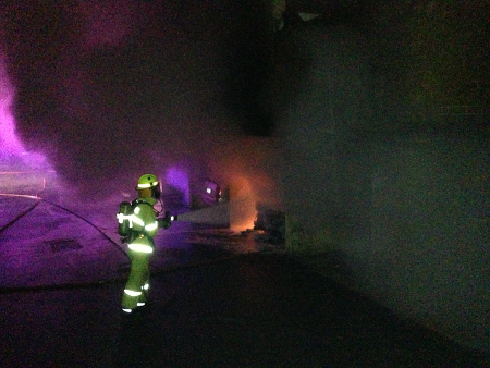 Firefighter battles the car fire in Jerilderie Court