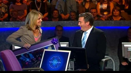 Livinia Nixon presents Eddie McGuire with some farewell gifts