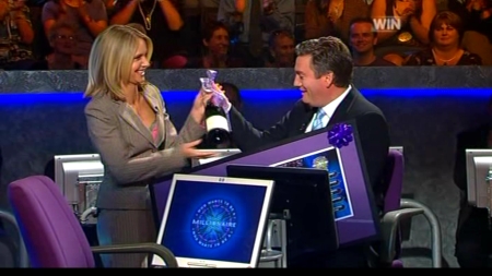 Livinia Nixon presents Eddie McGuire with some farewell gifts