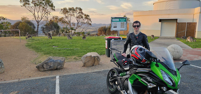 Samuel and motorbike on Mt Stromlo